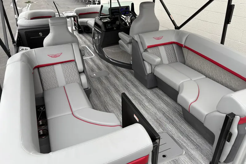 Slide: The Image of 2026 Bennington 24 MFB boat interior with luxurious gray seating and red accents. - 5