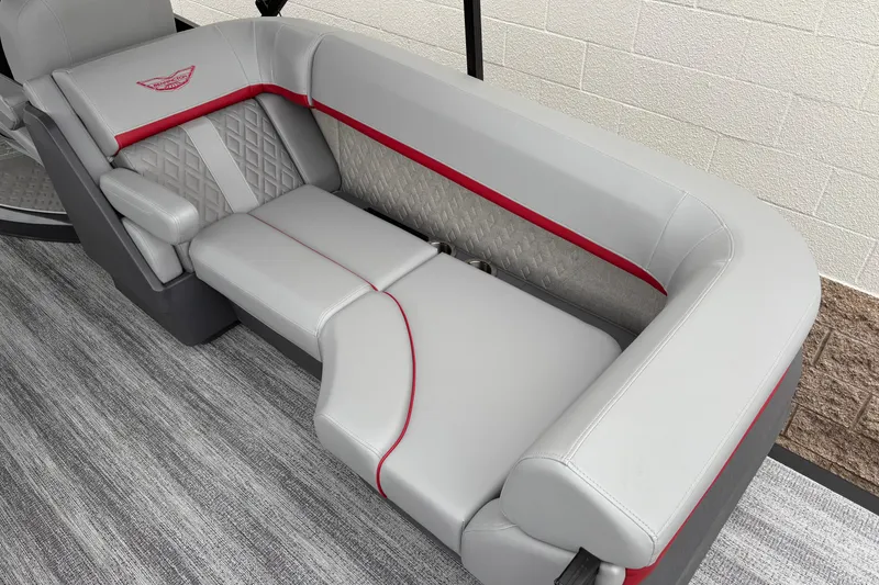 Slide: The Image of Luxurious seating on 2026 Bennington 24 MFB boat with gray upholstery and red accents. - 8