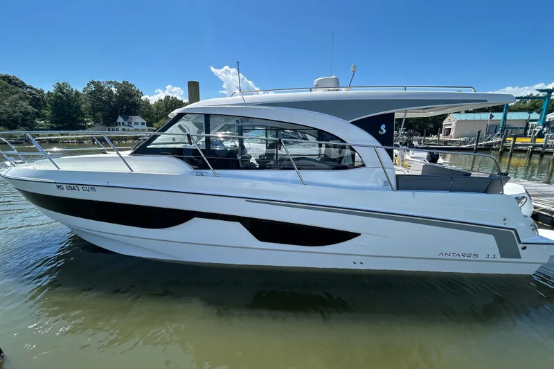 Slide: The Image of 2024 Beneteau Antares 11 boat docked on a sunny day, side view. - 0