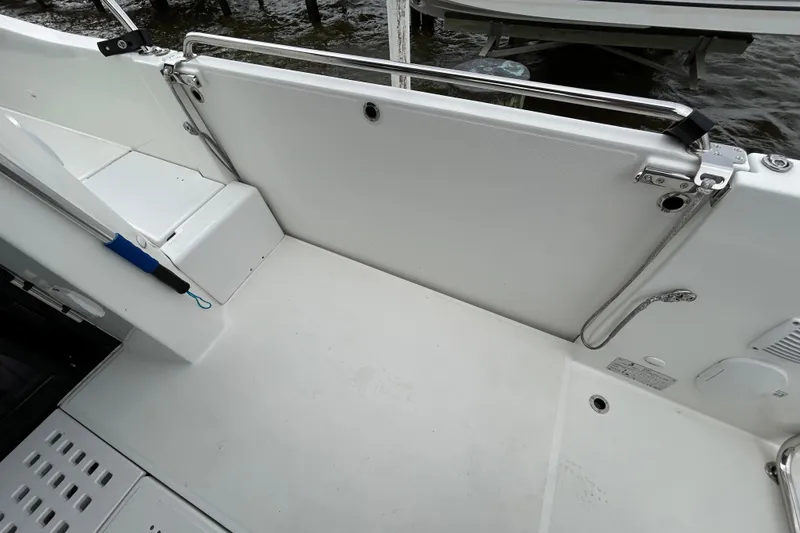 Slide: The Image of 2024 Beneteau Antares 11 boat deck with safety rail and clean white finish. - 11