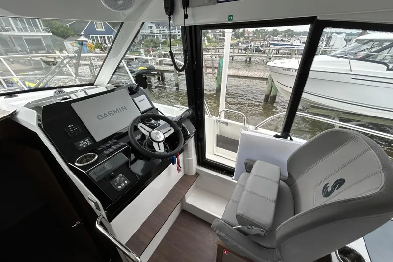 Slide: The Image of 2024 Beneteau Antares 11 helm with Garmin navigation, dockside view. - 12