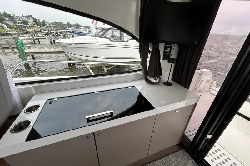 Slide: The Image of Interior view of 2024 Beneteau Antares 11 yacht with sleek kitchen and waterfront scenery. - 17