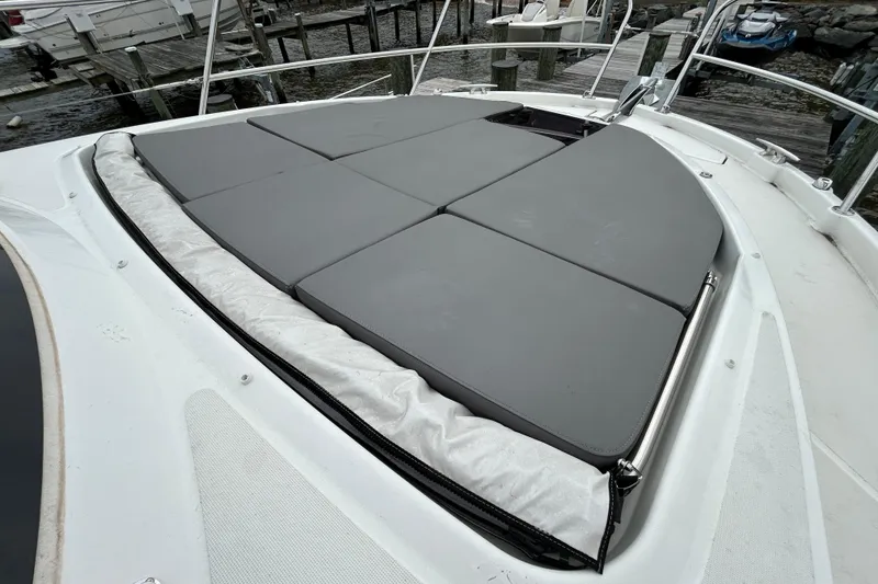 Slide: The Image of 2024 Beneteau Antares 11 boat with cushioned sunbathing area on deck. - 3