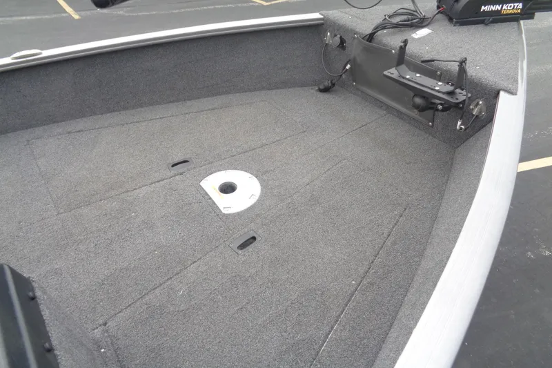 Slide: The Image of 2022 Lund 1775 Adventure SS boat interior with carpeted deck and Minn Kota trolling motor. - 12