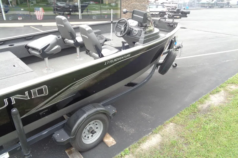 Slide: The Image of 2022 Lund 1775 Adventure SS boat on trailer, featuring dual seats and steering console. - 2