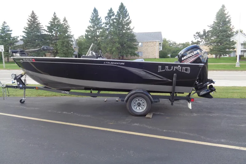 Slide: The Image of 2022 Lund 1775 Adventure SS boat on trailer, parked outdoors. - 23
