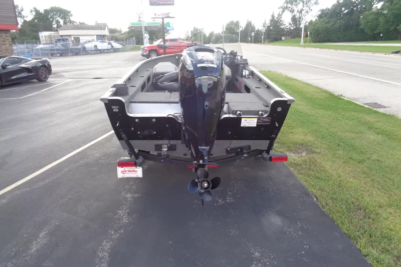 Slide: The Image of 2022 Lund 1775 Adventure SS boat with outboard motor, parked on a paved lot. - 25