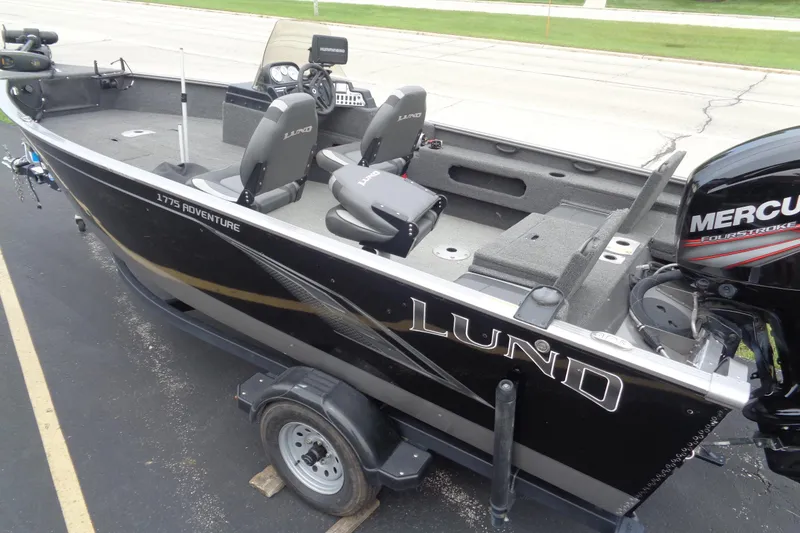 Slide: The Image of 2022 Lund 1775 Adventure SS boat with Mercury engine, parked on a trailer. - 3