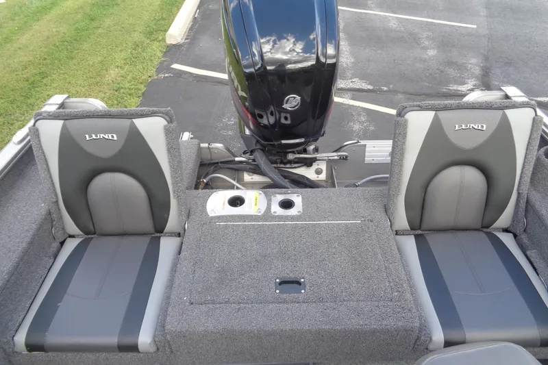 Slide: The Image of 2022 Lund 1775 Adventure SS boat interior with dual seats and motor. - 33