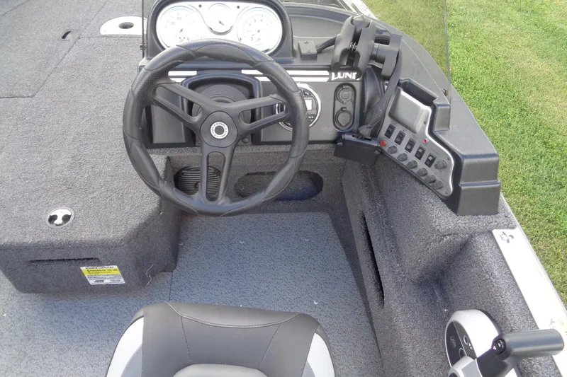 Slide: The Image of 2022 Lund 1775 Adventure SS boat cockpit with steering wheel and control panel. - 34