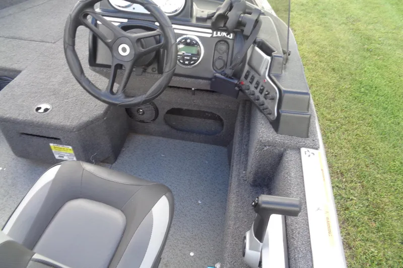 Slide: The Image of 2022 Lund 1775 Adventure SS boat interior with steering wheel and control panel. - 36