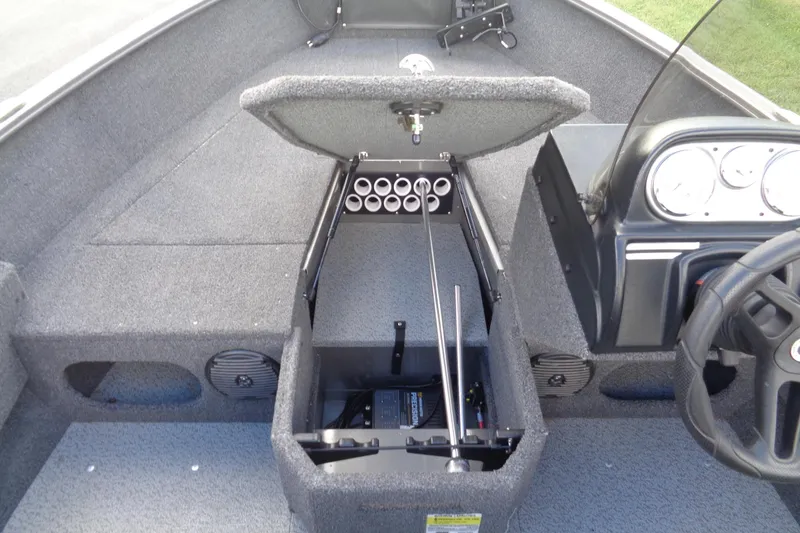 Slide: The Image of 2022 Lund 1775 Adventure SS boat interior with open storage compartment and steering console. - 37