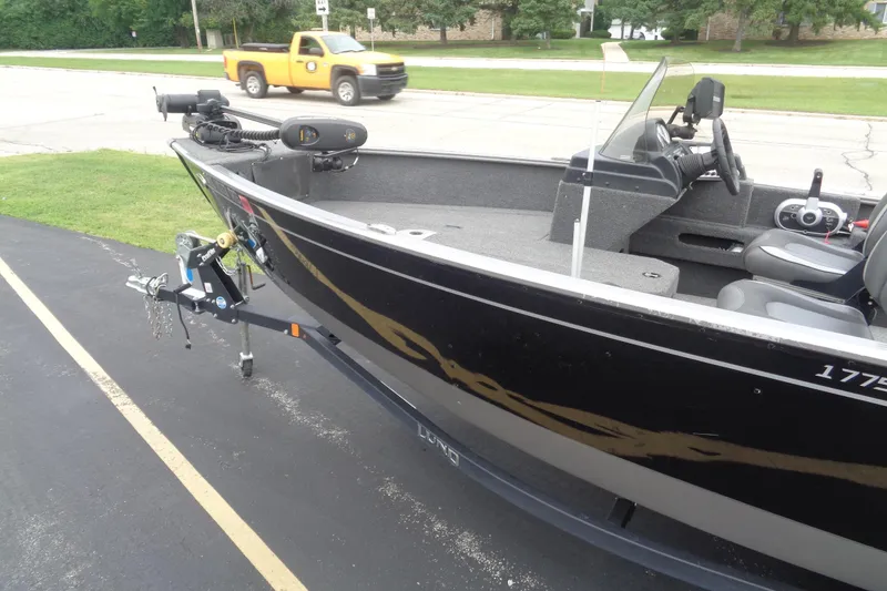 Slide: The Image of 2022 Lund 1775 Adventure SS boat on trailer, parked on driveway. - 4