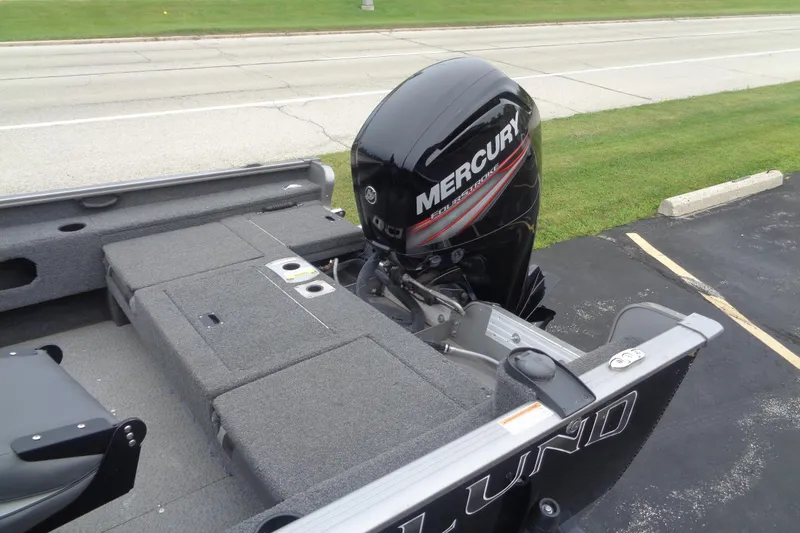 Slide: The Image of 2022 Lund 1775 Adventure SS boat with Mercury outboard motor, parked on pavement. - 5