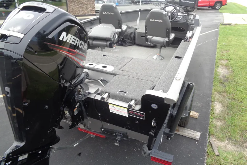 Slide: The Image of 2022 Lund 1775 Adventure SS boat with Mercury engine, parked on pavement. - 8