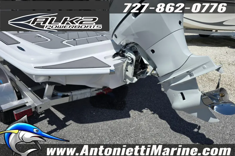 Slide: The Image of 2025 ALK2 Powerboats 22BHX FLATS/BAY HYBRID on trailer, featuring outboard motor. - 22