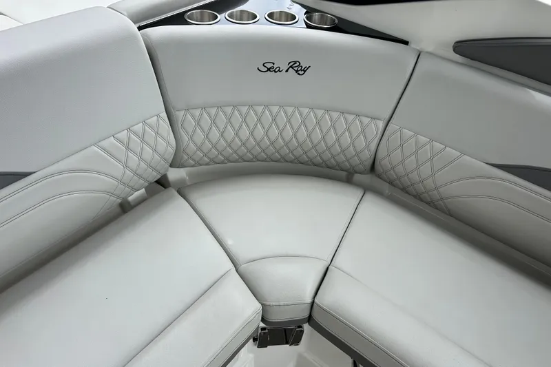 Slide: The Image of 2023 Sea Ray SLX 260 boat interior with luxurious seating and cup holders. - 11
