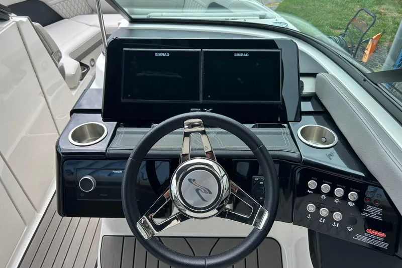 Slide: The Image of 2023 Sea Ray SLX 260 helm with Simrad display and modern controls. - 14