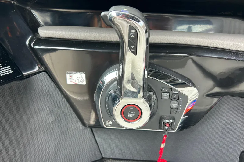 Slide: The Image of Throttle control panel of 2023 Sea Ray SLX 260 boat with start/stop button. - 21