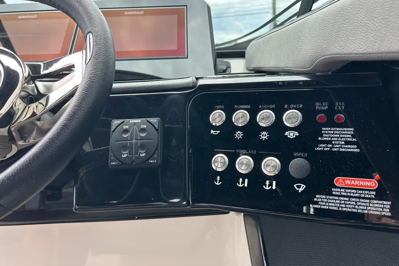 Slide: The Image of 2023 Sea Ray SLX 260 dashboard with steering wheel and control panel buttons. - 22