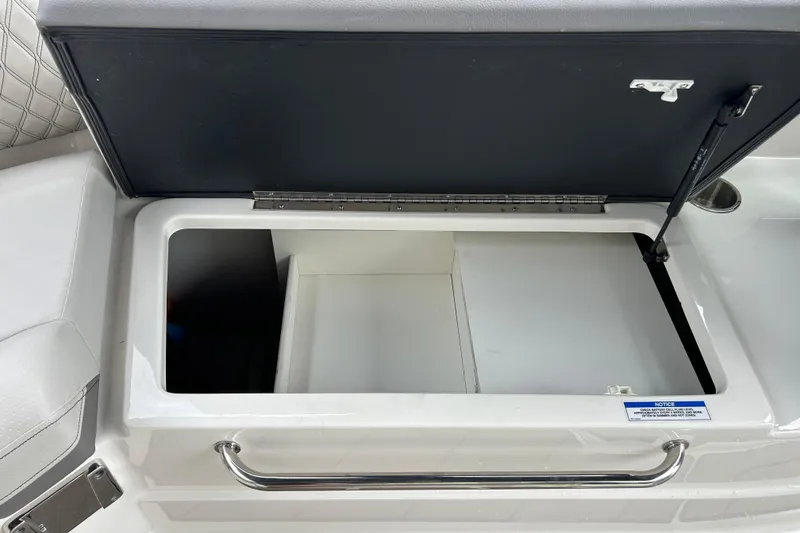 Slide: The Image of Open storage compartment on 2023 Sea Ray SLX 260 boat, featuring sleek design and ample space. - 24