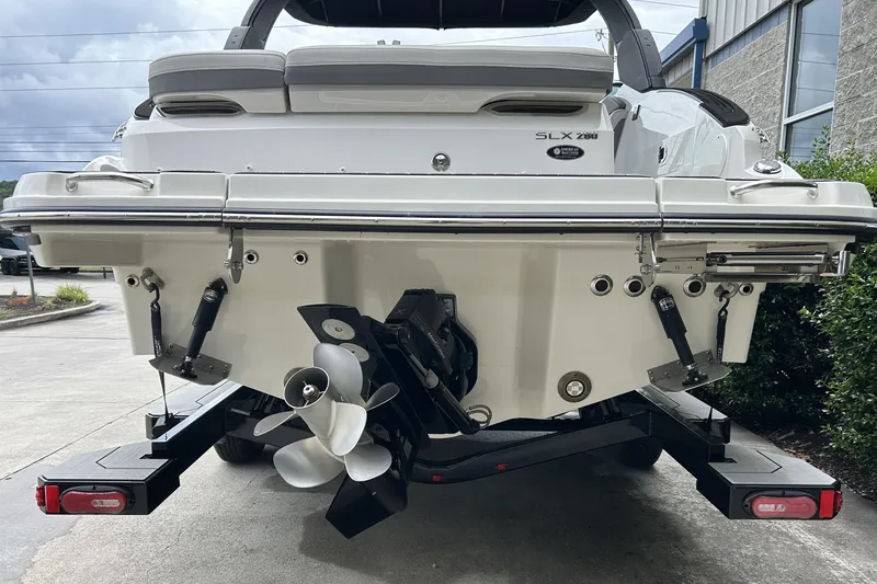 Slide: The Image of 2023 Sea Ray SLX 260 boat rear view with propeller and trailer. - 5
