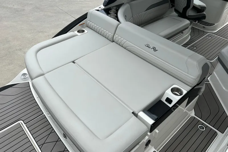 Slide: The Image of 2023 Sea Ray SLX 260 boat interior with luxurious seating and cup holders. - 7