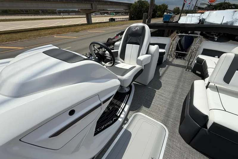 Slide: The Image of 2024 Barletta CORSA 23QSS boat interior with sleek seating and modern helm design. - 12
