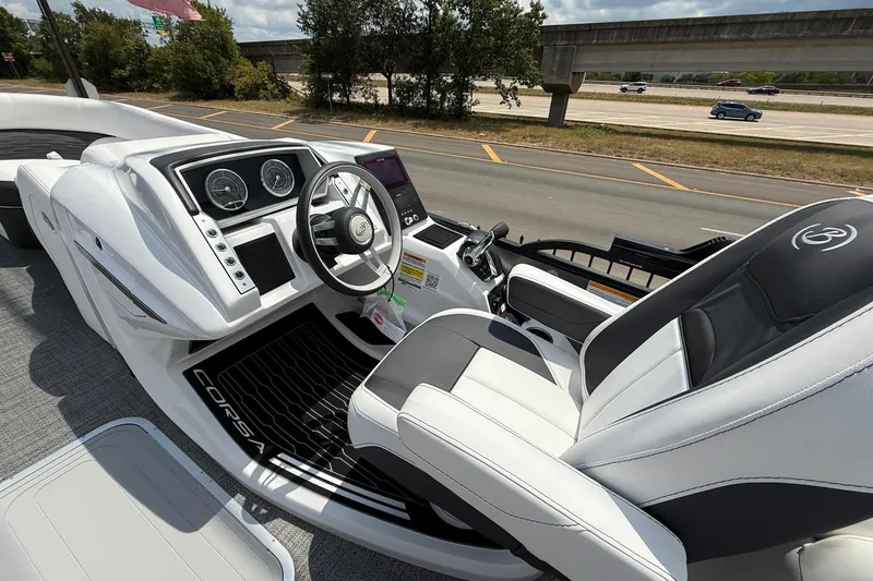 Slide: The Image of 2024 Barletta CORSA 23QSS boat interior with sleek dashboard and comfortable seating. - 13
