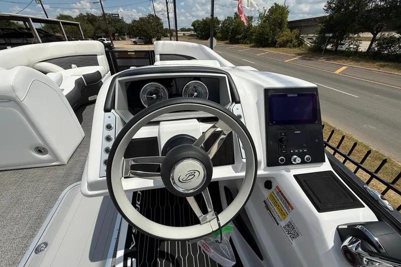 Slide: The Image of 2024 Barletta CORSA 23QSS boat dashboard with steering wheel and control panel. - 14