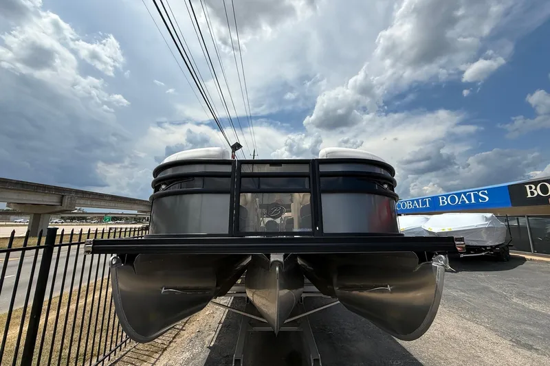 Slide: The Image of 2024 Barletta CORSA 23QSS pontoon boat displayed outdoors under cloudy sky. - 3