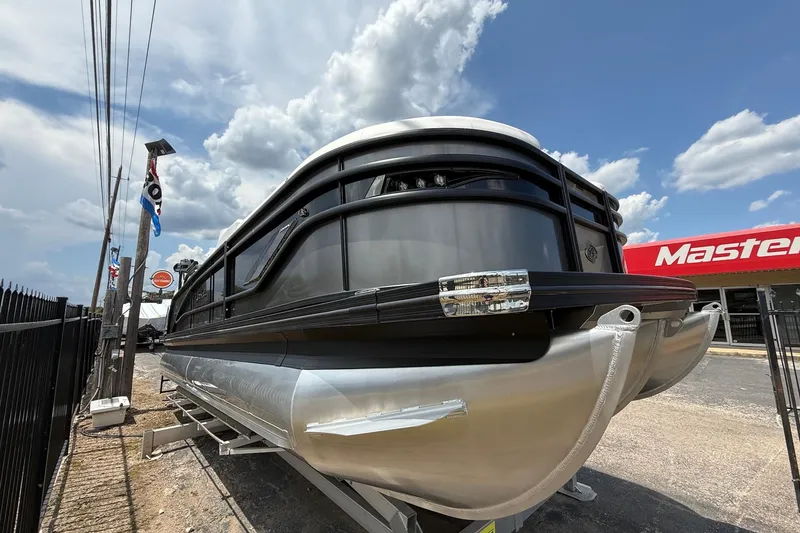 Slide: The Image of 2024 Barletta CORSA 23QSS pontoon boat displayed outdoors under a cloudy sky. - 4