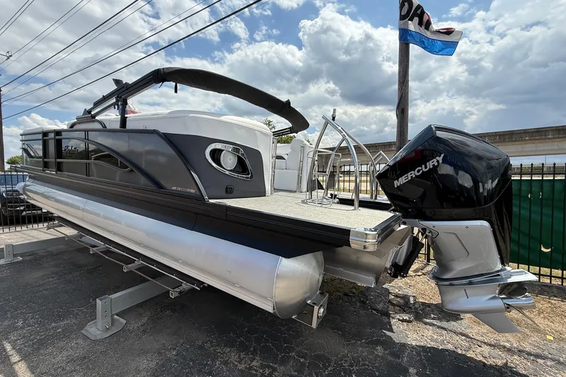 Slide: The Image of 2024 Barletta CORSA 23QSS pontoon boat with Mercury engine, displayed outdoors. - 6