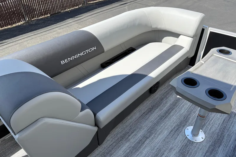 Slide: The Image of 2026 Bennington 21 SSR boat interior with gray seating and cupholder table. - 10