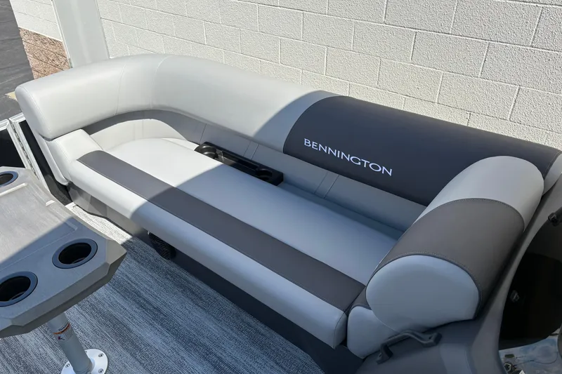 Slide: The Image of 2026 Bennington 21 SSR boat seating with cup holders, featuring sleek gray upholstery. - 11