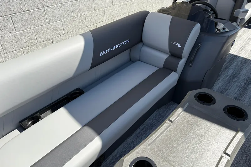 Slide: The Image of 2026 Bennington 21 SSR boat interior with gray seating and cup holders. - 13