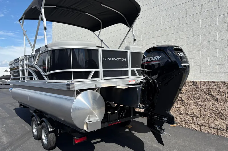 Slide: The Image of 2026 Bennington 21 SSR pontoon boat with Mercury outboard motor on trailer. - 2