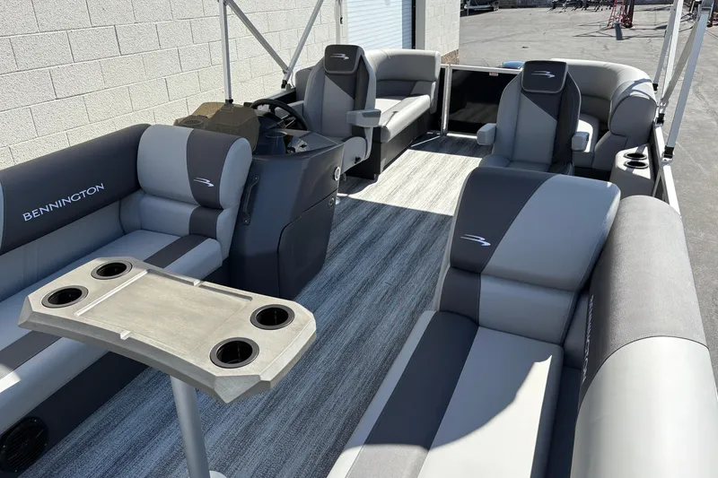 Slide: The Image of 2026 Bennington 21 SSR pontoon boat interior with gray seating and cup holders. - 3