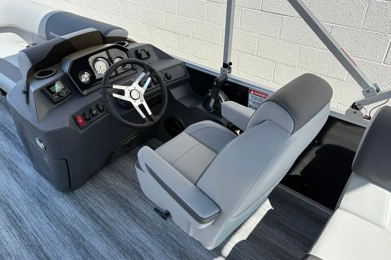 Slide: The Image of 2026 Bennington 21 SSR boat interior with steering wheel and dashboard controls. - 7