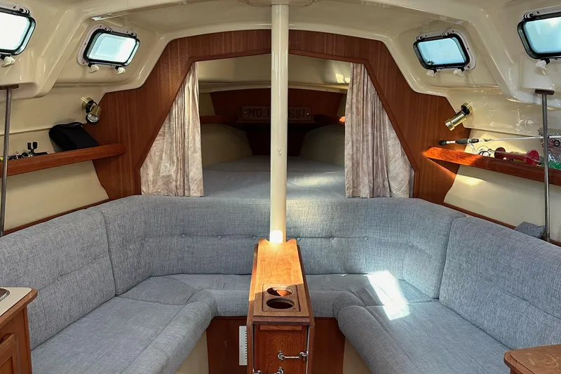 Slide: The Image of Interior of a 1992 Hunter 28 sailboat with cozy seating and wooden accents. - 3