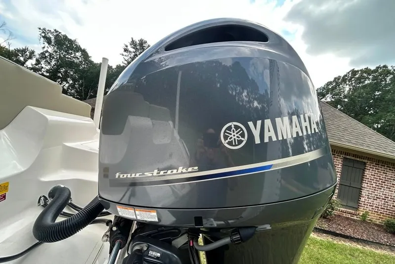 Slide: The Image of Yamaha four-stroke engine on 2022 Key West 219 FS boat, outdoors. - 11