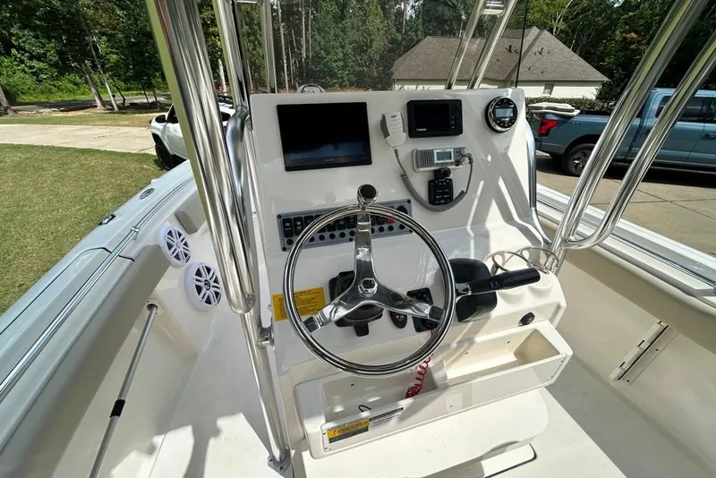 Slide: The Image of 2022 Key West 219 FS boat console with steering wheel, electronics, and controls. - 12