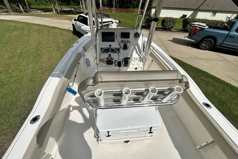Slide: The Image of 2022 Key West 219 FS boat interior with steering console and rod holders. - 13