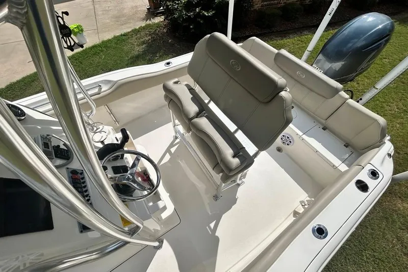Slide: The Image of 2022 Key West 219 FS boat interior with steering wheel and seating. - 17