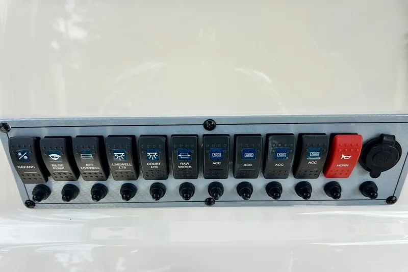 Slide: The Image of Control panel of a 2022 Key West 219 FS boat with labeled switches and buttons. - 21