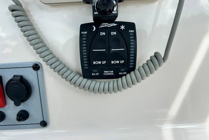 Slide: The Image of Control panel of a 2022 Key West 219 FS boat with trim tab controls. - 23