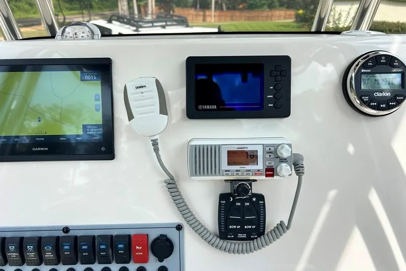 Slide: The Image of Control panel of 2022 Key West 219 FS boat with Garmin, Yamaha, and Clarion systems. - 24