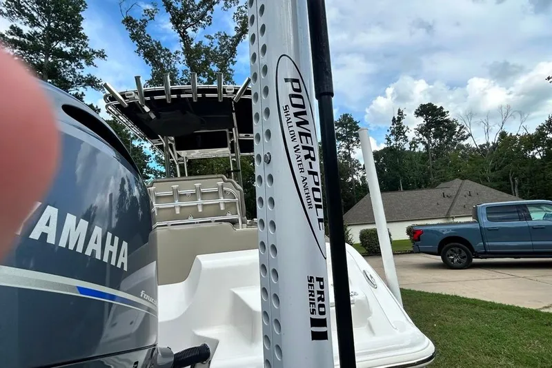 Slide: The Image of 2022 Key West 219 FS boat with Yamaha engine and Power-Pole anchor, parked near a house. - 27