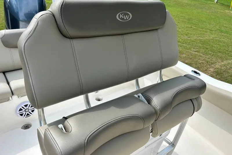 Slide: The Image of 2022 Key West 219 FS boat seating with gray upholstery and cup holders. - 29