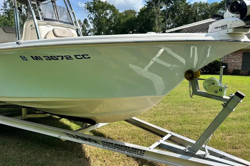 Slide: The Image of 2022 Key West 219 FS boat on trailer, displayed outdoors. - 47